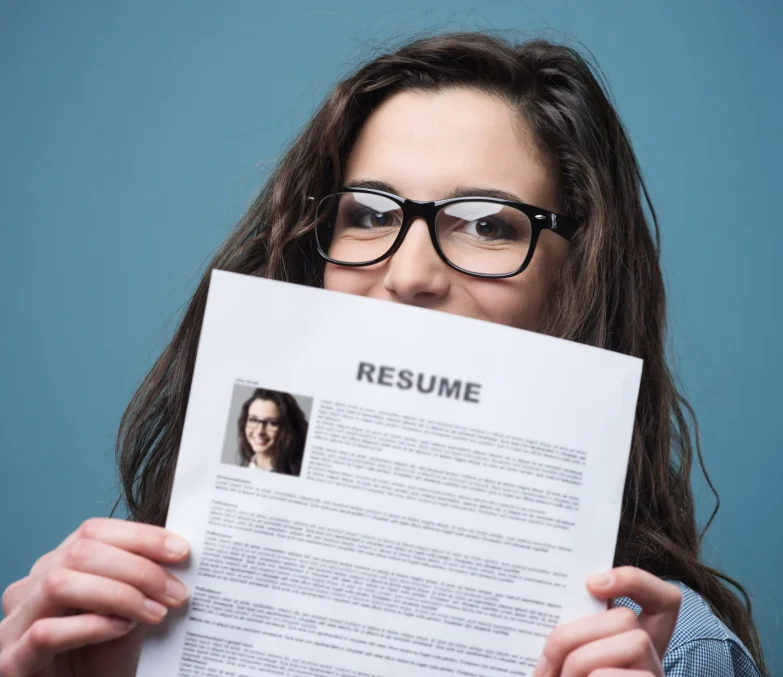 Young woman hiding behind her resume